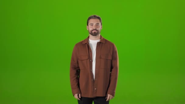 Man pointing down on empty space of chroma key background — Stockvideo
