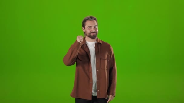 Man doing happy thumbs up gesture over green background — Video Stock