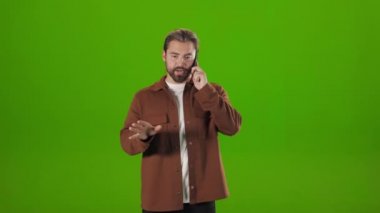 Man talking on mobile with serious facial expression