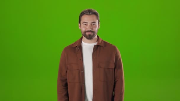 Caucasian man standing in studio and winking on camera — Stock Video