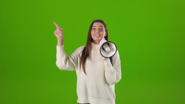 Woman using megaphone while gesturing and talking in studio — Wideo stockowe