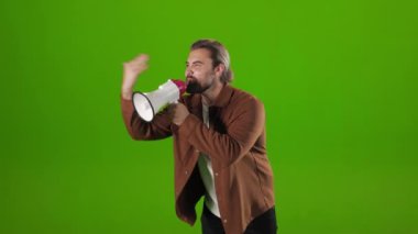 Emotional man gesturing and shouting in megaphone