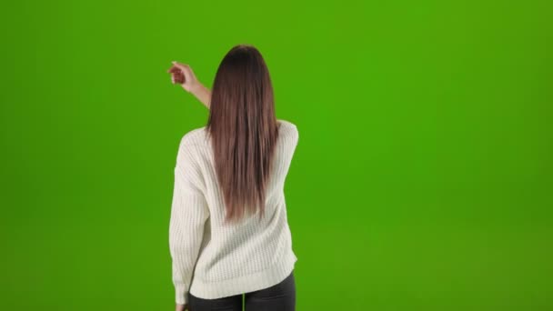 Back view of woman sliding and tapping with arm in studio — Video Stock