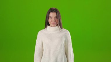 Portrait of young woman smiling on camera in studio