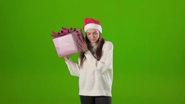 Woman shaking with gift box for checking whats inside — Stock Video