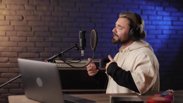 Музикант співає в мікрофоні на студії звукозапису — стокове відео