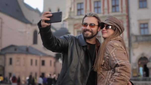İki sevecen insan dışarıda cep telefonuyla selfie çekiyor. — Stok video