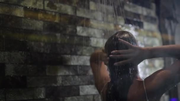 Vista posteriore della donna che prende doccia rinfrescante in camera d'albergo — Video Stock