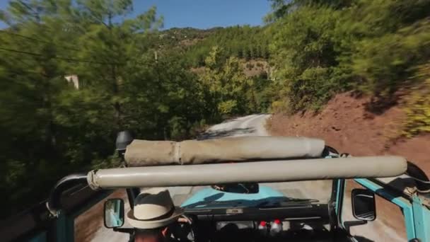 Voiture bleue chevauchant sur la route parmi les hautes montagnes vertes — Video