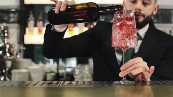 Gekwalificeerde Barman Zwart Pak Die Sinaasappeldrank Glas Giet Met Ijsblokjes — Stockvideo