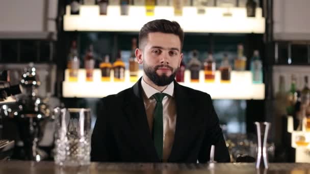 白胡子酒保身穿黑色西服 两臂交叉 站在吧台前看着镜头 人的概念 职业和餐馆服务 — 图库视频影像