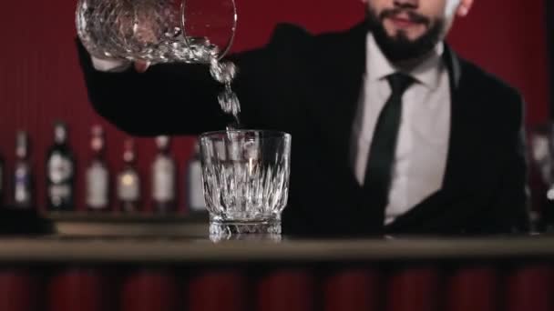 Caucasian Bearded Barkeeper Filling Shiny Glass Ice Cubes While Standing — Stock Video