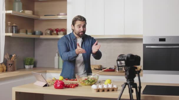 Handsome Caucasian Man Doing Live Streaming While Cooking Healthy Meal — Stock Video