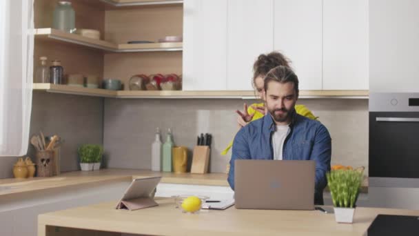 Focused Caucasian Man Working Modern Laptop Bright Kitchen While Wife — Video