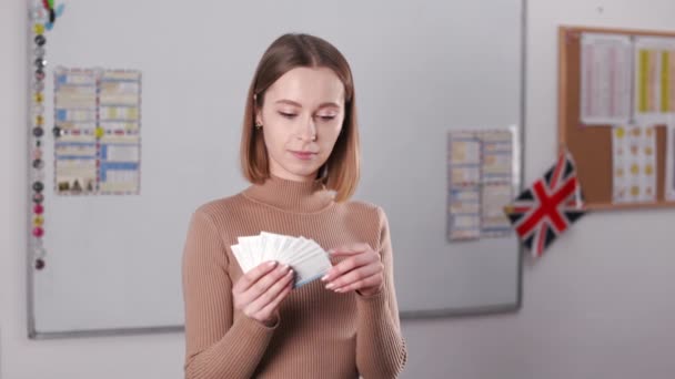Portrait Cheerful Young Woman Pointing Finger Paper Cards English Words — Stok Video