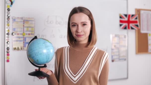 Portrait Positive English Tutor Holding Spinning Globe Hands While Looking — Video Stock