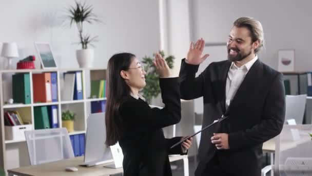 Beautiful Asian Woman Giving High Five Her Caucasian Colleague While — Stok video