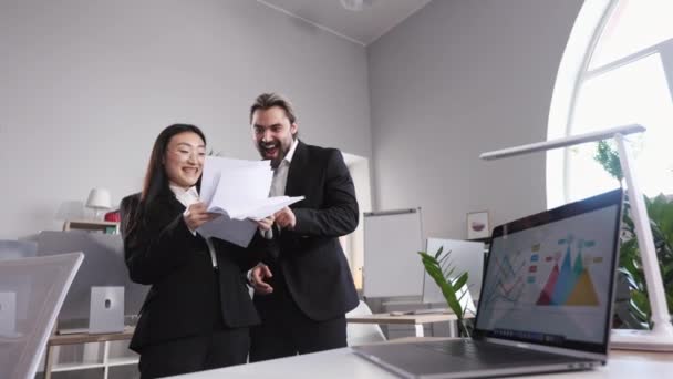 Happy Male Female Colleagues Looking Documents While Standing Middle Office – Stock-video