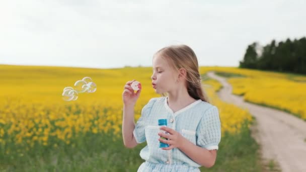 Wesoła Biała Dziewczyna Pięknej Letniej Sukience Dmuchając Bańki Mydlane Stojąc — Wideo stockowe