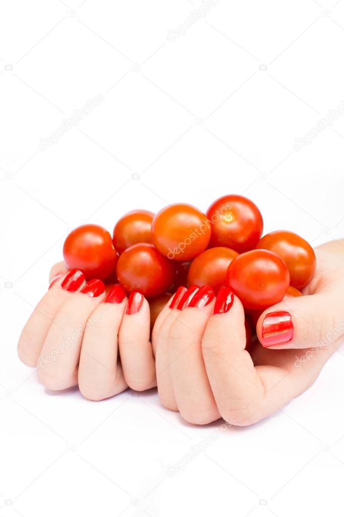 Two hands holding cherry tomatoes