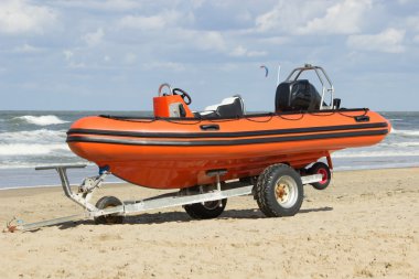 Trailer with boat for emergency services on the beach clipart