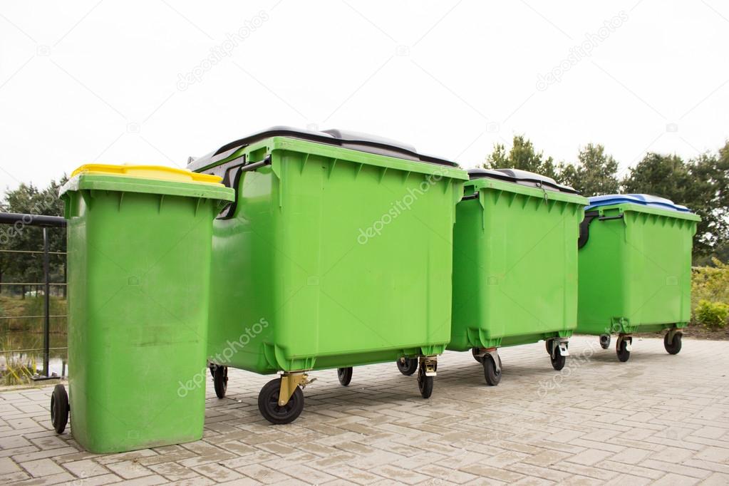 Green garbage containers in a row