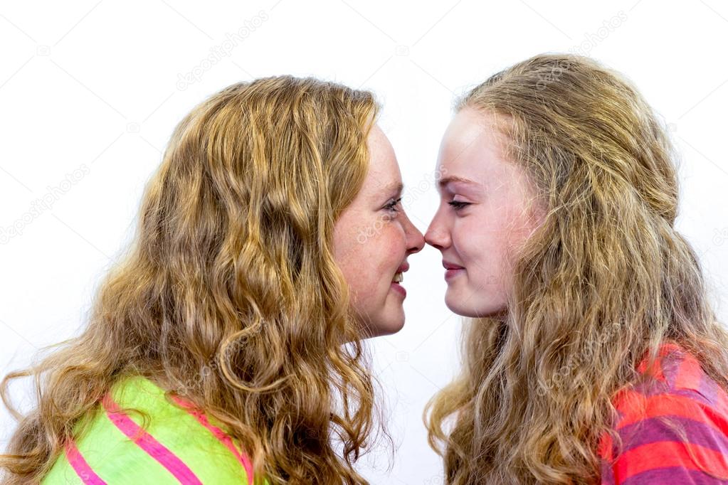 Two teenage girls noses making contact