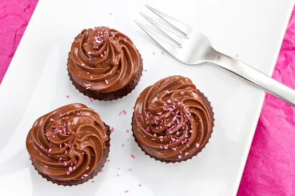 Chocolate cupcakes with pink coconut sprinkles — Stock Photo, Image