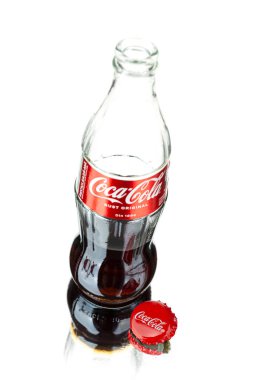 Chisinau, Moldova - July 31, 2022: Classic bottle of Coca-Cola, open bottle isolated on white background