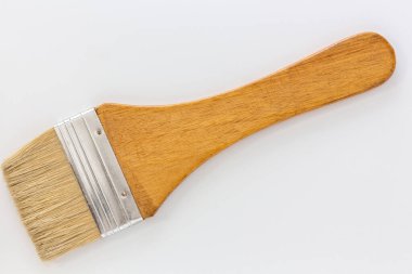 Synthetic paint brush, flat, white hair with wooden handle.