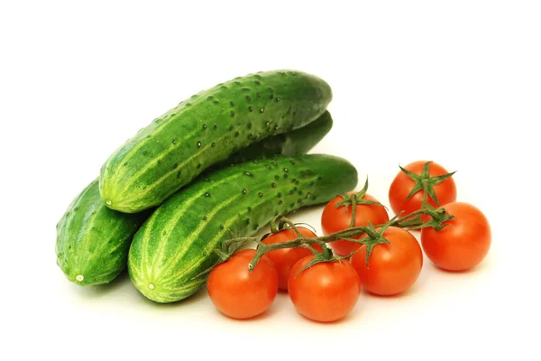 Red cherry tomatoes and green cucumbers — Stock Photo, Image