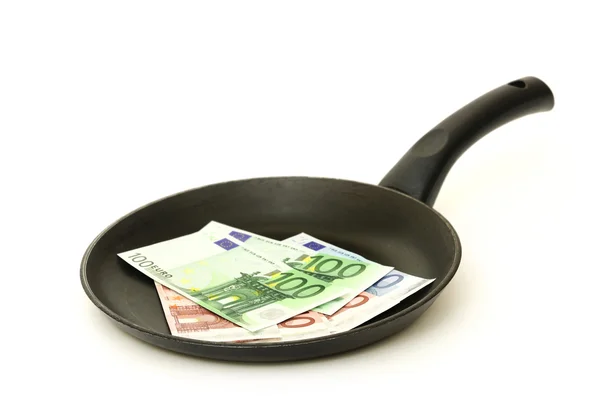 Frying pan with banknotes on a white background — Stock Photo, Image