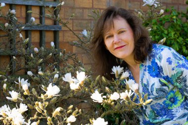 Güzel ve mutlu bir bayanı yakalayıp Mart ayında Magnolia Stellata çiçeklerinin ve bahar güneşinin tadını çıkarıyorum..