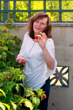 Çekici bir esmer yakalayıp bahçesinde ahududu toplayıp yemekten zevk alıyor..