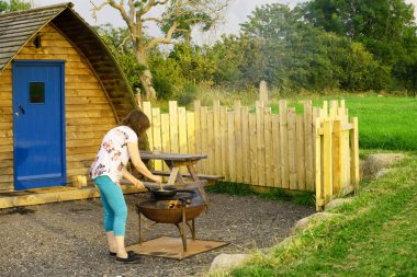 Firepits provide lovely additional warmth on cooler summer evenings and are a popular extra for contemporary glamping. They are helpful for cooking if designed appropriately with an additional grill.