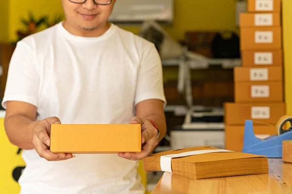 Man wearing white shirt will send the parcel. box delivery concept. Packaging boxes for express delivery. happy man  with pick up and delivery with fast delivery service. transportation concept.