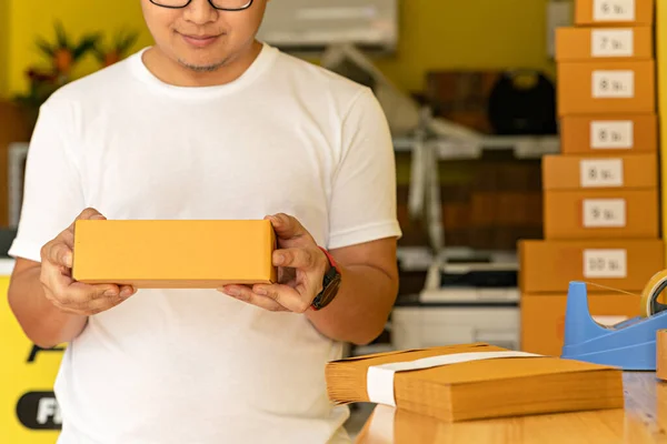 Man wearing white shirt will send the parcel. box delivery concept. Packaging boxes for express delivery. happy man  with pick up and delivery with fast delivery service. transportation concept.