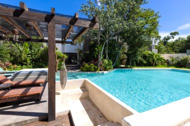 Mexico, Tulum upscale hotel patio with jungle views and hammock.