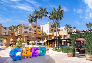 Cabo San Lucas, Los Cabos, Mexico, 2 October, 2021: Los Cabos colorful letters in Cabo San Lucas marina a departure point for cruises, marlin fishing and lancha boats to El Arco Arch and beaches clipart