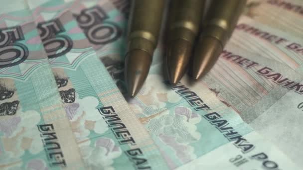 Kalashnikov AK 47 Bullets on Russian Ruble Banknotes, War and Economy Concept — Stock Video