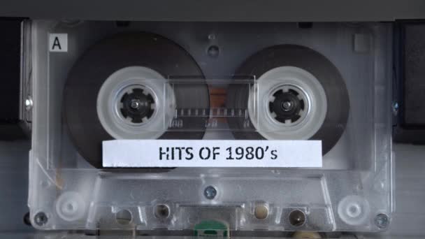 Hits of 1980 Music Compilation, Audio Cassette Tape Rolling in Vintage Player — 비디오