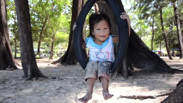 Thai child on a tire swing — Stock Video