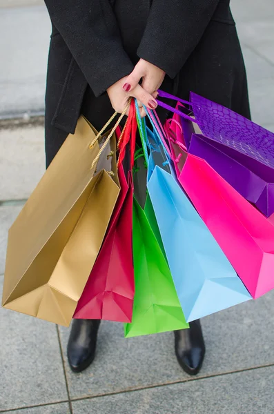 Parts of body of young woman with shopping bags — Stock Photo, Image