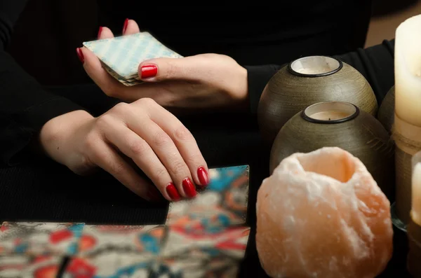 Hands of young woman with divination cards — Stock Photo, Image