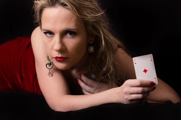 Woman in red with playing card — Stock Photo, Image