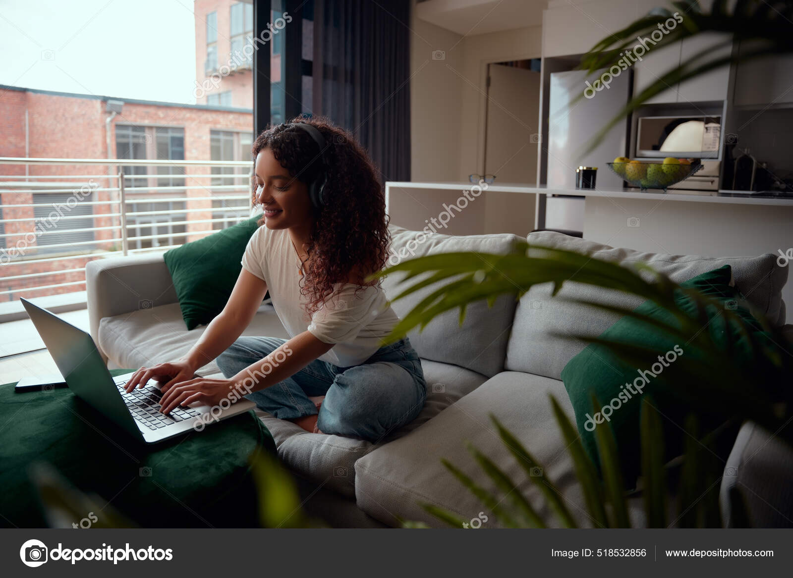 Friends Using Laptop On Sofa Mixed Race Typing Having Photo