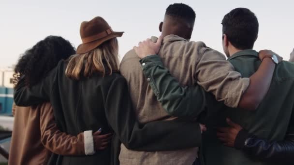 Diverso grupo de amigos adultos jóvenes brazo en brazo mirando la vista desde una azotea al atardecer. — Vídeos de Stock