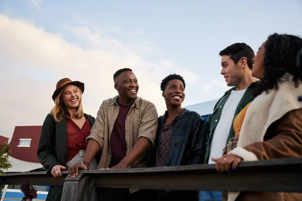 Trendy, diverse group of friends standing and chatting together on rooftop at party in the city — Stock Photo, Image