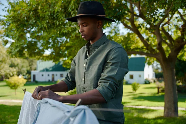 Mixed Race Male Farmer Hanging Out Dirty Laundry Washing Line — Stock Photo, Image