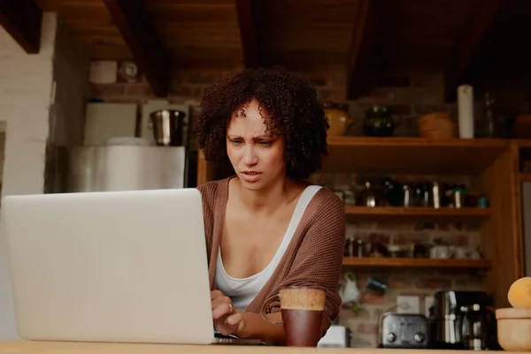 Young Biracial Woman Casual Clothing Frowning While Working Laptop Kitchen — Stockfoto
